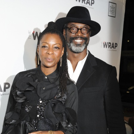 Jenisa Garland and her husband in matching black outfits.